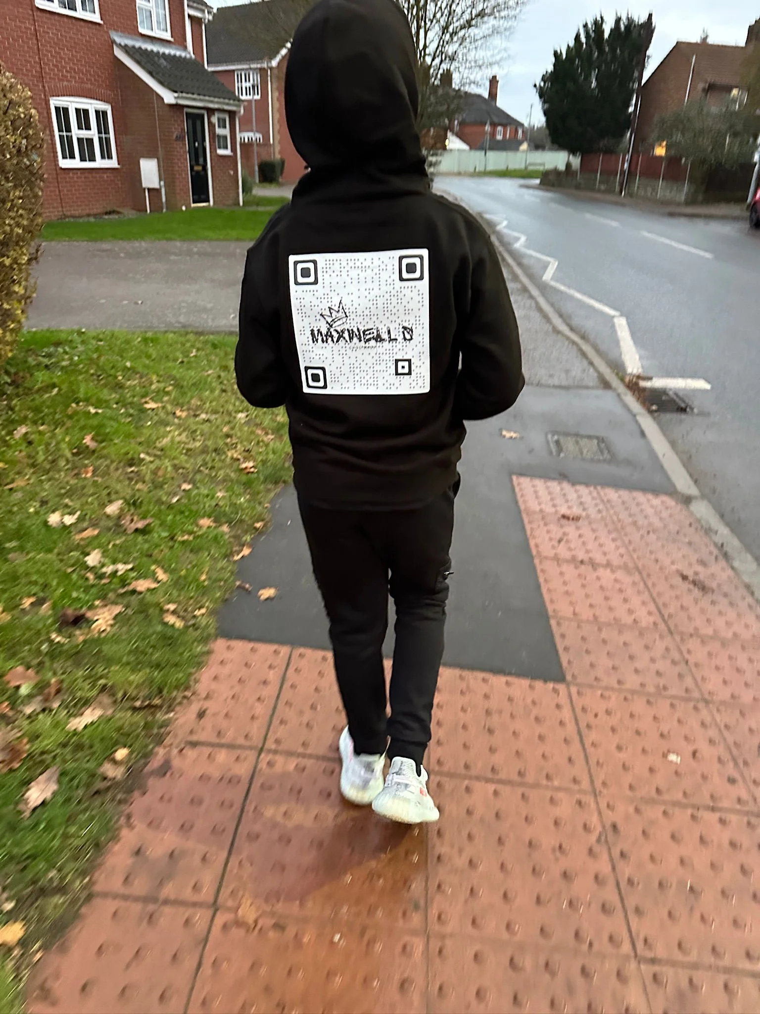 Kid wearing a QR code possibly for their business
